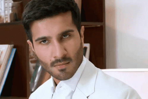 A Man With A Beard Is Wearing A White Jacket GIF