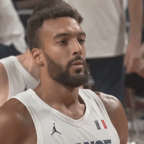 A Man With A Beard Is Wearing A White Jersey With The Number 11 On The Front GIF