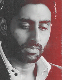A Man With A Beard Is Wearing A White Shirt GIF