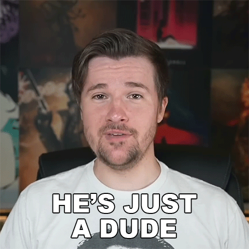 A Man With A Beard Is Wearing A White Shirt That Says He 'S Just A Dude On It GIF