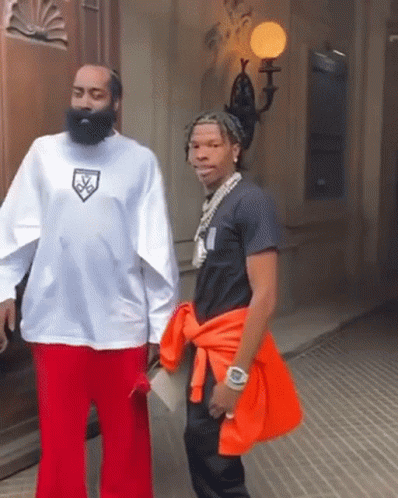 A Man With A Beard Is Wearing A White Shirt With A Logo On It GIF