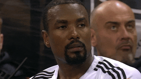A Man With A Beard Is Wearing A White Shirt With Black Stripes GIF