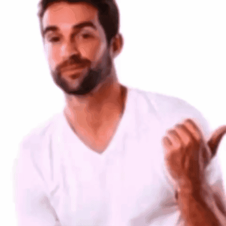 A Man With A Beard Is Wearing A White T-Shirt And Giving A Thumbs Up . GIF