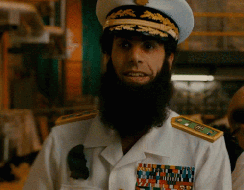 Bearded Man In White Uniform With Gold Shoulder Badges GIF