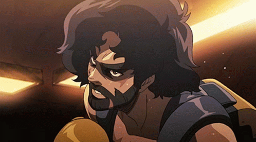 A Man With A Beard Is Wearing Boxing Gloves In A Dark Room GIF