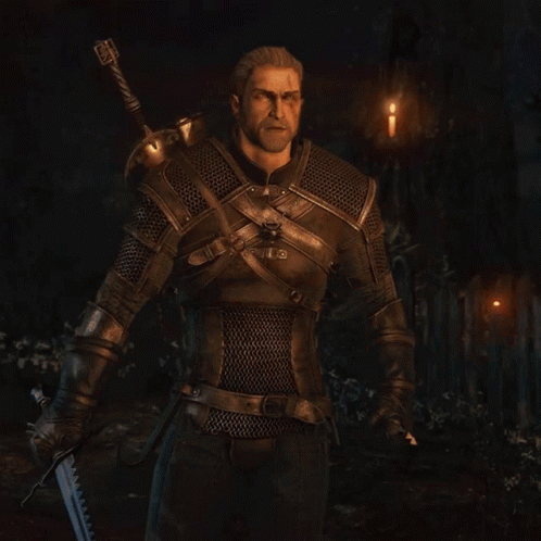 A Man With A Beard Is Wearing Chain Mail And A Sword GIF