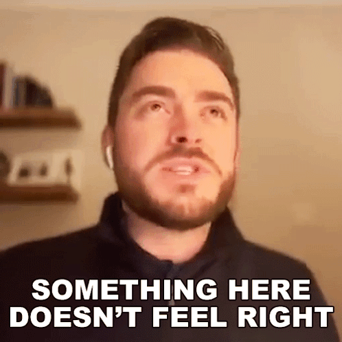 A Man With A Beard Is Wearing Ear Buds And Saying Something Here Does N't Feel Right . GIF