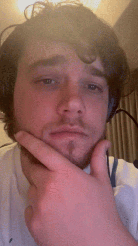 A Man With A Beard Is Wearing Headphones And Making A Funny Face GIF