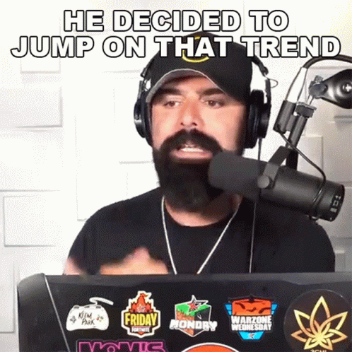 A Man With A Beard Is Wearing Headphones And Talking Into A Microphone With The Words He Decided To Jump On That Trend GIF