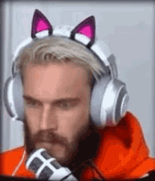 A Man With A Beard Is Wearing Headphones With Cat Ears On His Head . GIF