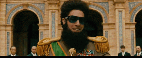 Bearded Man Wearing Sunglasses And Green Sash GIF