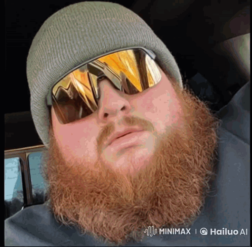 A Man With A Beard Is Wearing Sunglasses And A Hat GIF