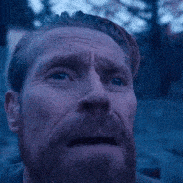 A Man With A Beard Looks Up At The Sky With His Eyes Closed GIF