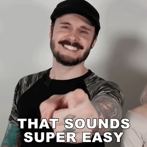 A Man With A Beard Pointing At The Camera With The Words That Sounds Super Easy Behind Him GIF