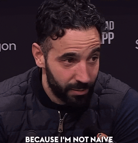 A Man With A Beard Says " Because I 'M Not Naive " In Front Of A Black Background GIF