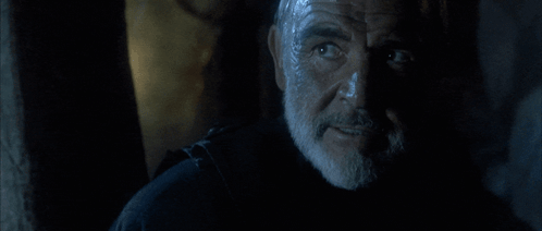 A Man With A Beard Says " Do N't Tempt Me " In A Dark Room GIF