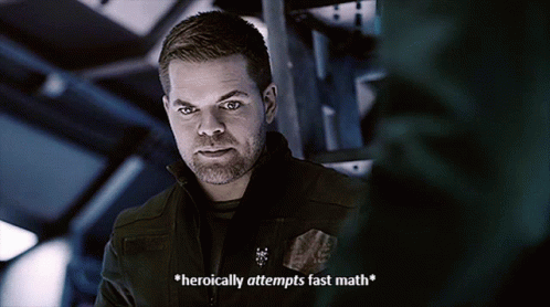 A Man With A Beard Says " Heroically Attempts Fast Math " In A Dark Room GIF