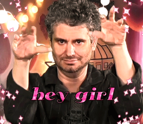 A Man With A Beard Says Hey Girl In Pink GIF