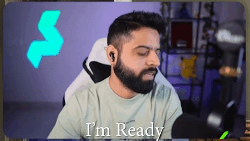 A Man With A Beard Says I 'M Ready While Sitting In Front Of A Microphone GIF