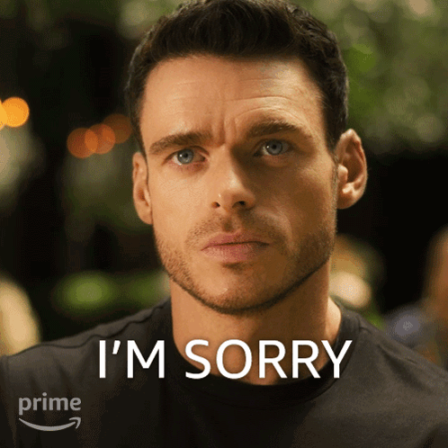 A Man With A Beard Says I 'M Sorry In Front Of An Amazon Prime Logo GIF