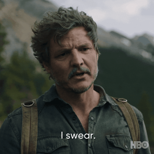 a man with a beard says i swear in front of a mountain