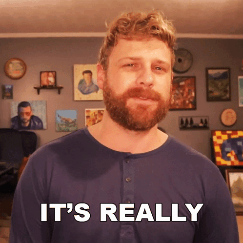 A Man With A Beard Says It 'S Really In Front Of A Wall Of Paintings GIF