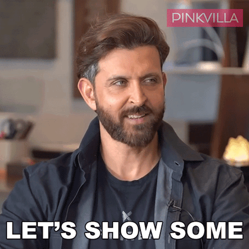 A Man With A Beard Says " Let 'S Show Some " In Front Of A Pinkvilla Logo GIF