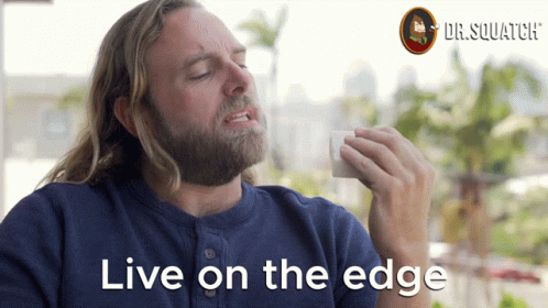 A Man With A Beard Says " Live On The Edge " In Front Of A Dr.squatch Logo GIF
