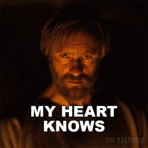 a man with a beard says " my heart knows " in front of him