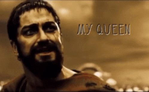 A Man With A Beard Says My Queen In Front Of A Crowd Of People GIF