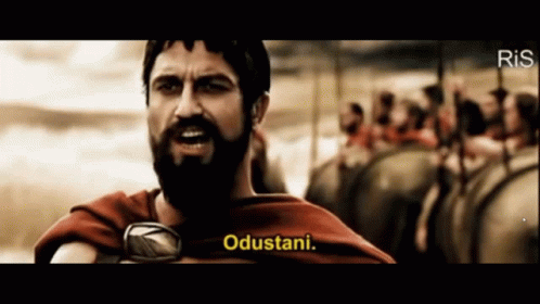 A Man With A Beard Says " Odustani " In Front Of A Crowd GIF