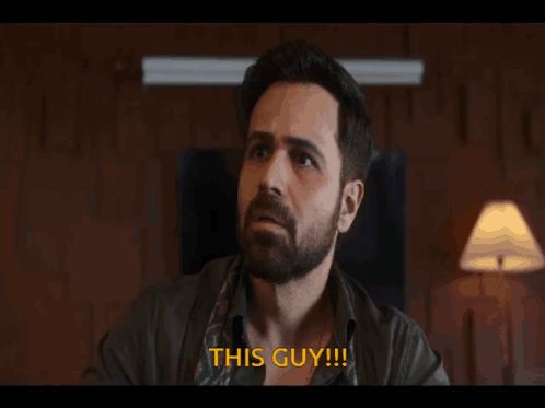 A Man With A Beard Says " This Guy " In Orange Letters GIF
