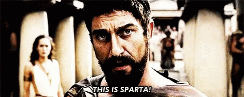 A Man With A Beard Says " This Is Sparta " In Front Of A Woman GIF