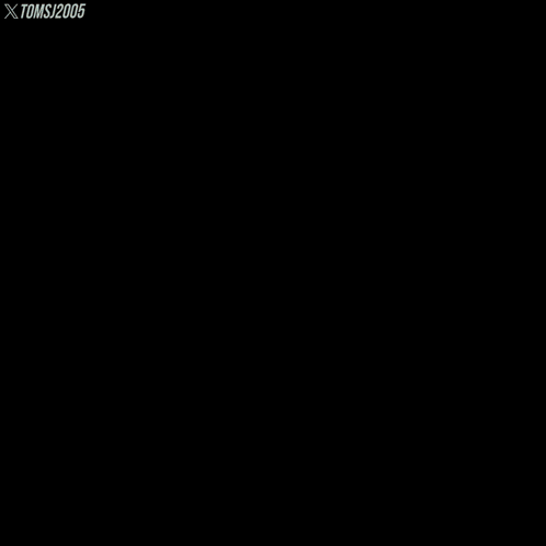 A Man With A Beard Sits In A Grassy Field With Toms 2005 Written On The Bottom Right GIF