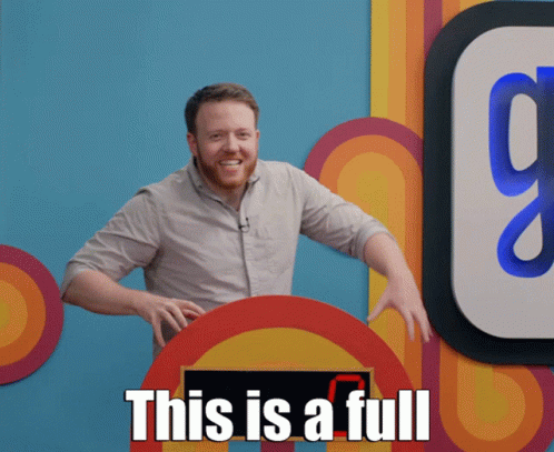 A Man With A Beard Stands In Front Of A Sign That Says " This Is A Full " GIF