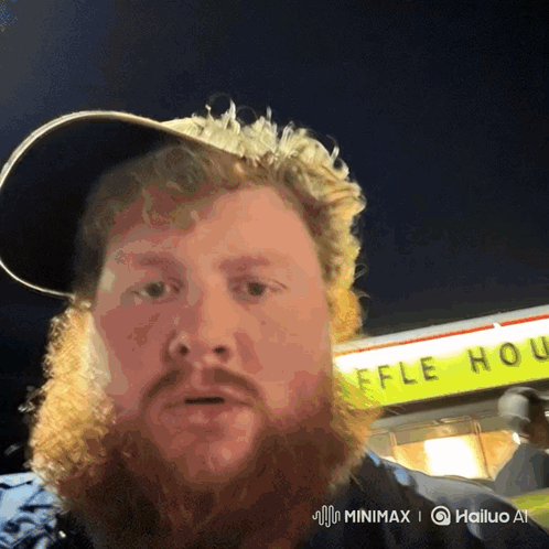 A Man With A Beard Stands In Front Of A Waffle House Sign GIF