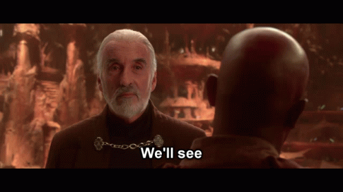 A Man With A Beard Talks To Another Man With The Words " We 'Ll See " Below Him GIF