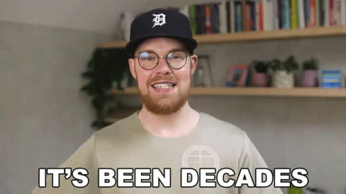 A Man With A Beard Wearing A Baseball Cap And Glasses Says It 'S Been Decades GIF