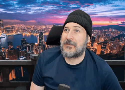 A Man With A Beard Wearing A Beanie And A Blue Shirt GIF