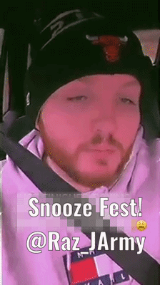 A Man With A Beard Wearing A Beanie And A Tommy Hilfiger Hoodie Is Sitting In A Car . GIF