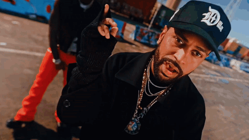 A Man With A Beard Wearing A Black Hat That Says 20 On It GIF