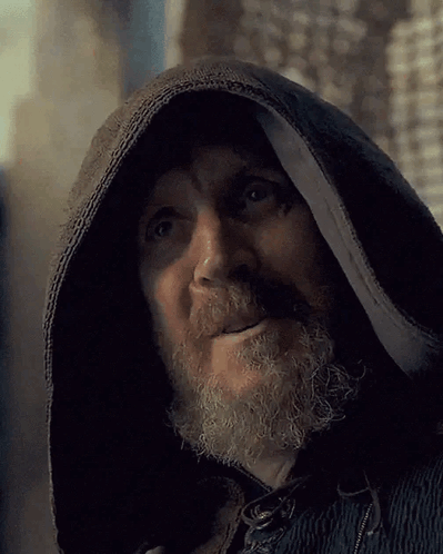 a man with a beard wearing a black hooded jacket