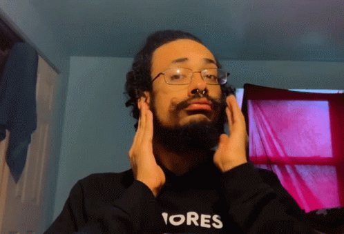 A Man With A Beard Wearing A Black Hoodie That Says Ores GIF