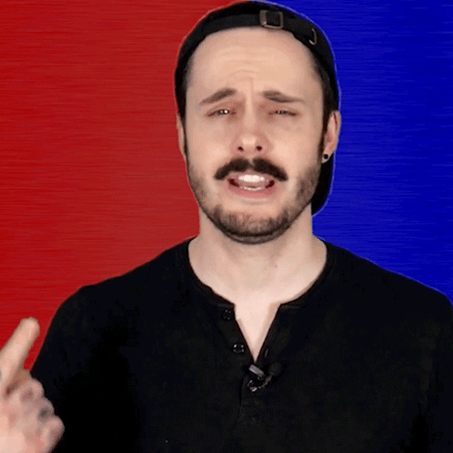 A Man With A Beard Wearing A Black Shirt And A Hat GIF