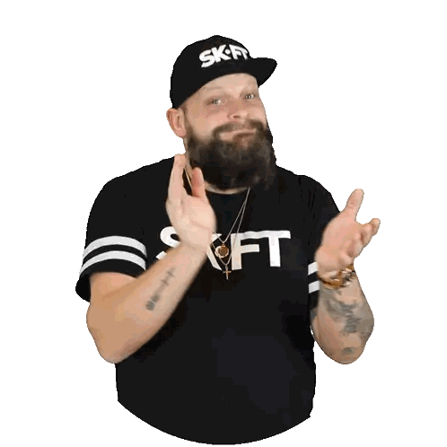 a man with a beard wearing a black shirt that says " skift " on it
