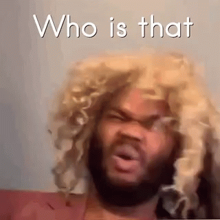 A Man With A Beard Wearing A Blonde Wig Is Making A Funny Face . GIF