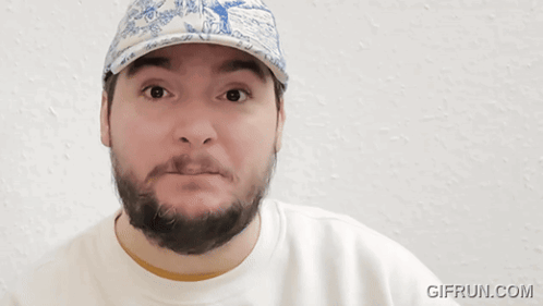 A Man With A Beard Wearing A Blue And White Hat With The Words This Boy 'S In Denial GIF