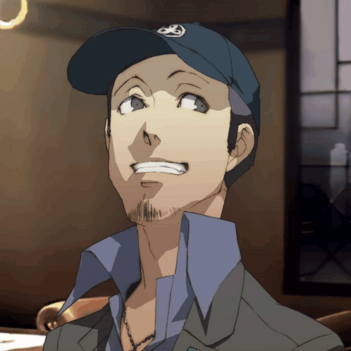A Man With A Beard Wearing A Blue Hat With A Circle On It GIF