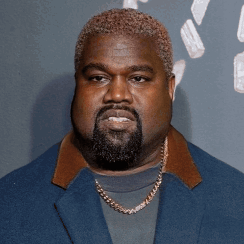A Man With A Beard Wearing A Blue Jacket And A Gold Chain GIF