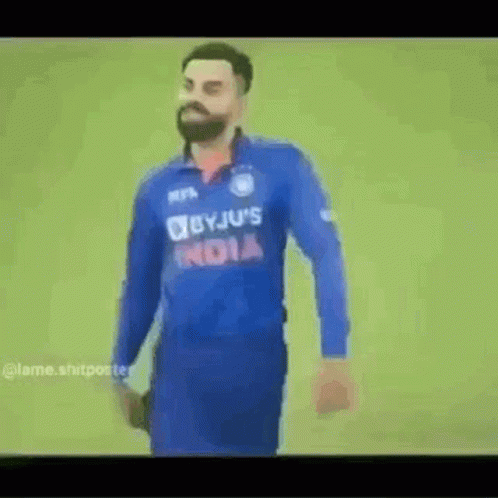 A Man With A Beard Wearing A Blue Jersey With The Word India On It . GIF